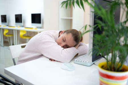 young woman is sad at the workplace. office work concep.の写真素材