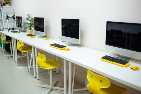 a cozy workplace in a coworking space with a computer and a flower in a pot.