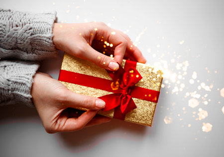 hands hold a gift on a white background.の写真素材