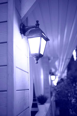 color of the year 2022 is very peri. street lamp on the wall of the cafe.の写真素材