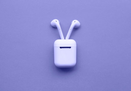 the color of 2022 is very peri. wireless headphones are a great backdrop for design.の写真素材