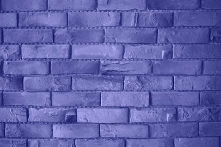 the color of 2022 is very peri. brick wall is a great background for design.の写真素材