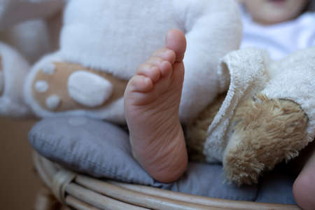 filming close-up. little leg of a cute boy sitting on a chair.の写真素材