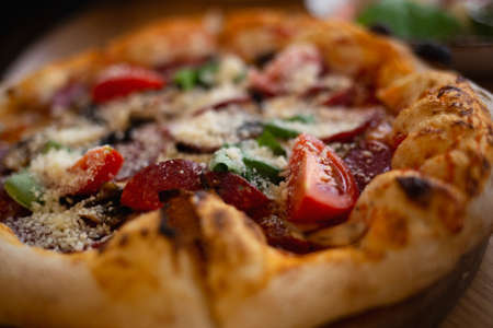 delicious fresh pizza with salami, basil and tomatoes.の写真素材