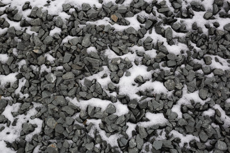 dark gray gravel in the snow. great background for your design.の写真素材