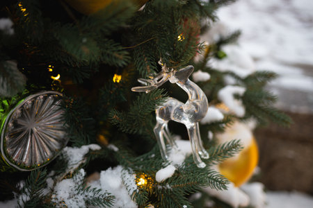 beautiful multi-colored toys on a Christmas tree against the background of lights and snow.の写真素材