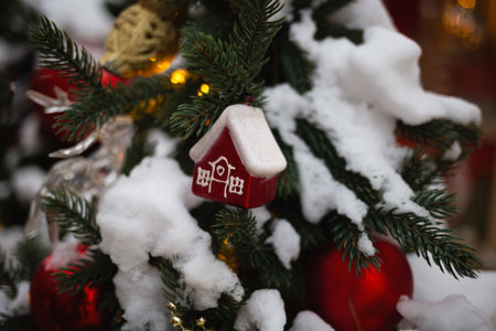 beautiful multi-colored toys on a Christmas tree against the background of lights and snow.の写真素材