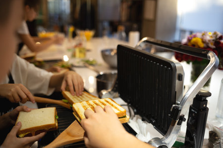 close-up shot. hands holding fresh chicken toast at food preparation master class.の写真素材