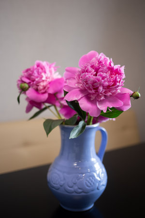 beautiful fresh pink peonies in a crock blue jugの写真素材
