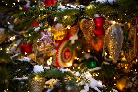 beautiful multi-colored toys on a Christmas tree against the background of lights and snow.の写真素材