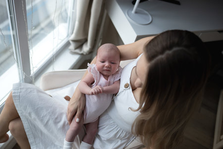 young beautiful woman kisses her little cute daughter. family portraitの写真素材