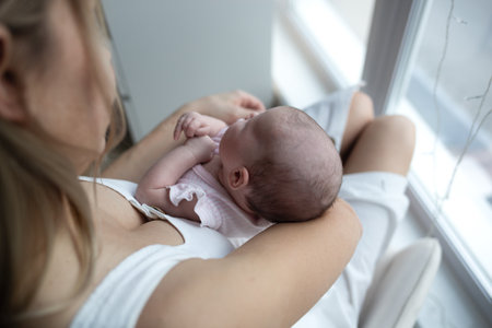 young beautiful woman kisses her little cute daughter. family portraitの写真素材
