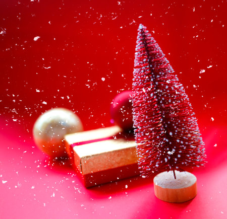 christmas tree and gifts on bright red backgroundの写真素材