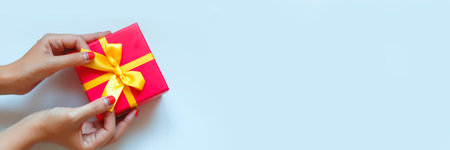 hands hold a gift on a white background.の写真素材