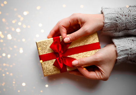hands hold a gift on a white background.の写真素材
