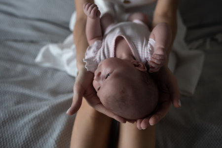 little cute baby girl lies in her mothers arms