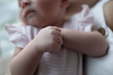 little cute baby girl lies in her mothers arms
