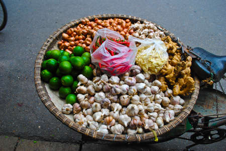 Straw tray of vegetables on a bicycle in Hanoiの写真素材