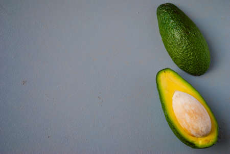 Top view of halved avocado on gray backgroundの写真素材