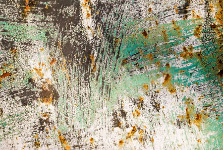 Rusty metal surface with black and aqua paint spots