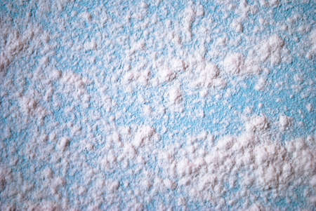 White flour on a turquoise wooden board
