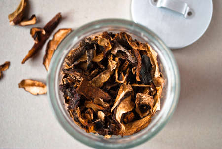 Dried mushrooms in glass jar on table. Top viewの写真素材