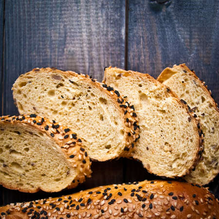 Slices of fresh baguette with white and black sesame. Close up. Top view