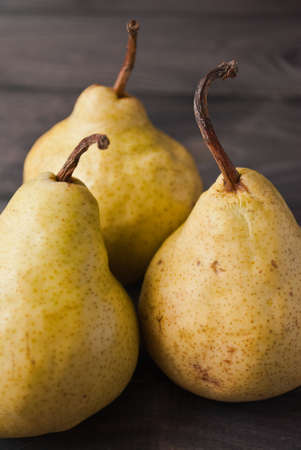 Group of whole yellow pears on rustic background. Close upの写真素材