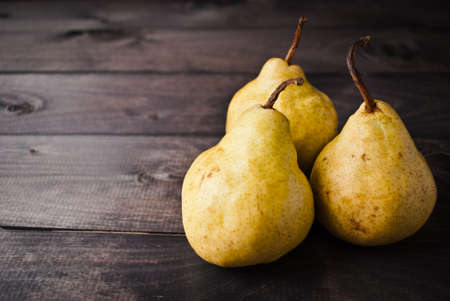 Group of whole yellow pears on rustic backgroundの写真素材