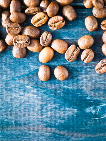 Coffee beans on bright turquoise shabby wooden backgroundの写真素材