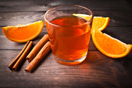 Cup of tea, cinnamon sticks and orange slicesの写真素材