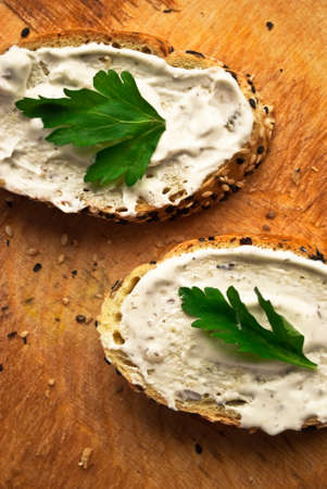 Sandwich with cream cheese and parsley on rustic wooden background. Close upの写真素材