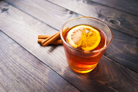 Cup of black tea with lemon slice and cinnamon sticks. Top viewの写真素材