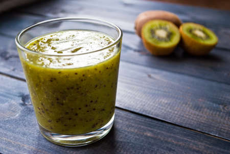 Fresh green smoothie from kiwi fruit in glass. Close upの写真素材