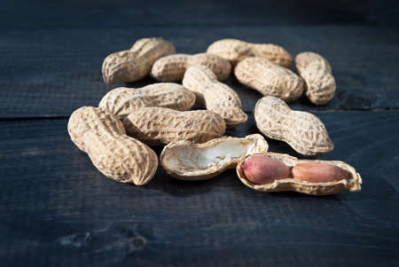 Heap of roasted peanuts on wooden backgroundの写真素材