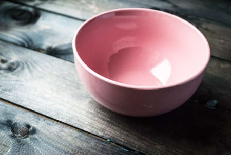 Empty pink plate on a wooden backgroundの写真素材