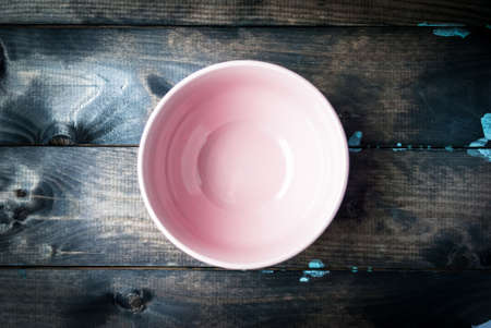 Empty pink bowl on a glossy wooden backgroundの写真素材