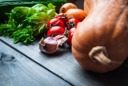 A lot of bright raw veggies for cooking fresh salad and stewed pumpkin, vegan recipeの写真素材