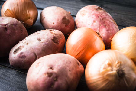 Raw potatoes and onions. Ingredients for cookingの写真素材