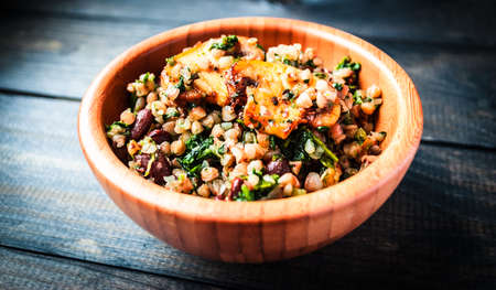 Bamboo bowl of boiled buckwheat with spinach and red beans with slices of fried champignon on the top, menu pageの写真素材