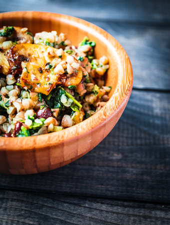 Bamboo bowl of boiled buckwheat with spinach and red beans with slices of fried champignon on the top, bannerの写真素材