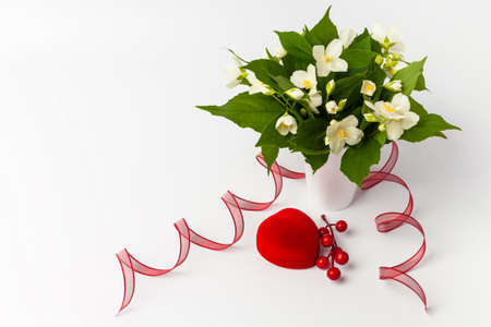 Gift box and beautiful flowers on whiteの写真素材