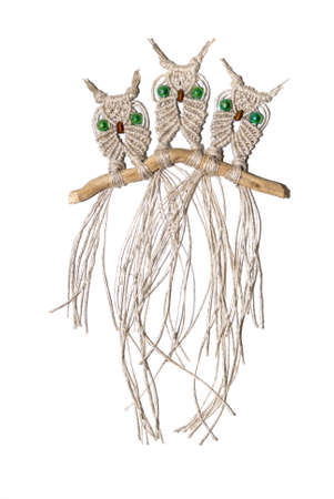 Three little owls woven out of cords and ropes using the art of macrameの写真素材