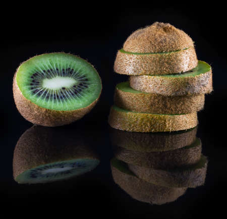 fresh kiwi on a black background with reflection closeupの写真素材