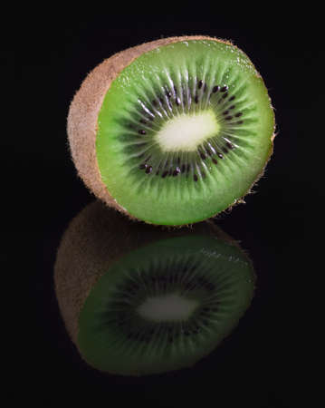 fresh kiwi on a black background with reflection closeupの写真素材