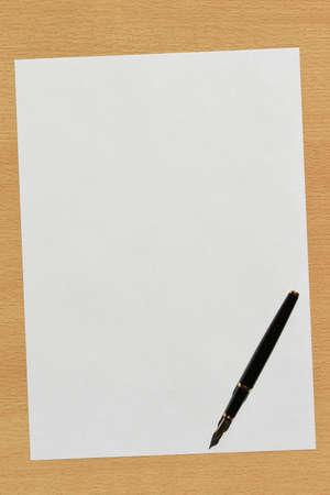 Clean white sheet of paper for entries with a black pen on the desktop in the office, copy spaceの写真素材