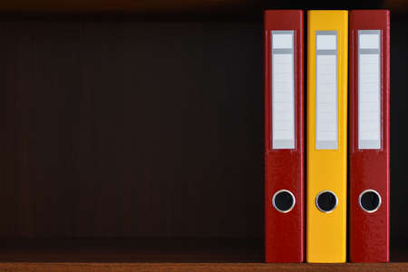 Folders for documents in the closet on the shelf in the office, files, copy space, background, close-up, office suppliesの写真素材