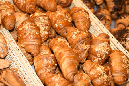 Beautiful delicious rolls, croissants, cakes and bread in the basket