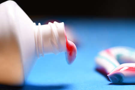 Healthy teeth. Hygiene of the oral cavity. Colored toothpaste from a tube
