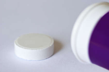 Tablet for health fitness slimming weight loss. Vitamins pills pill for a healthy lifestyle from a packing jar on a white background. Write copy pasteの写真素材